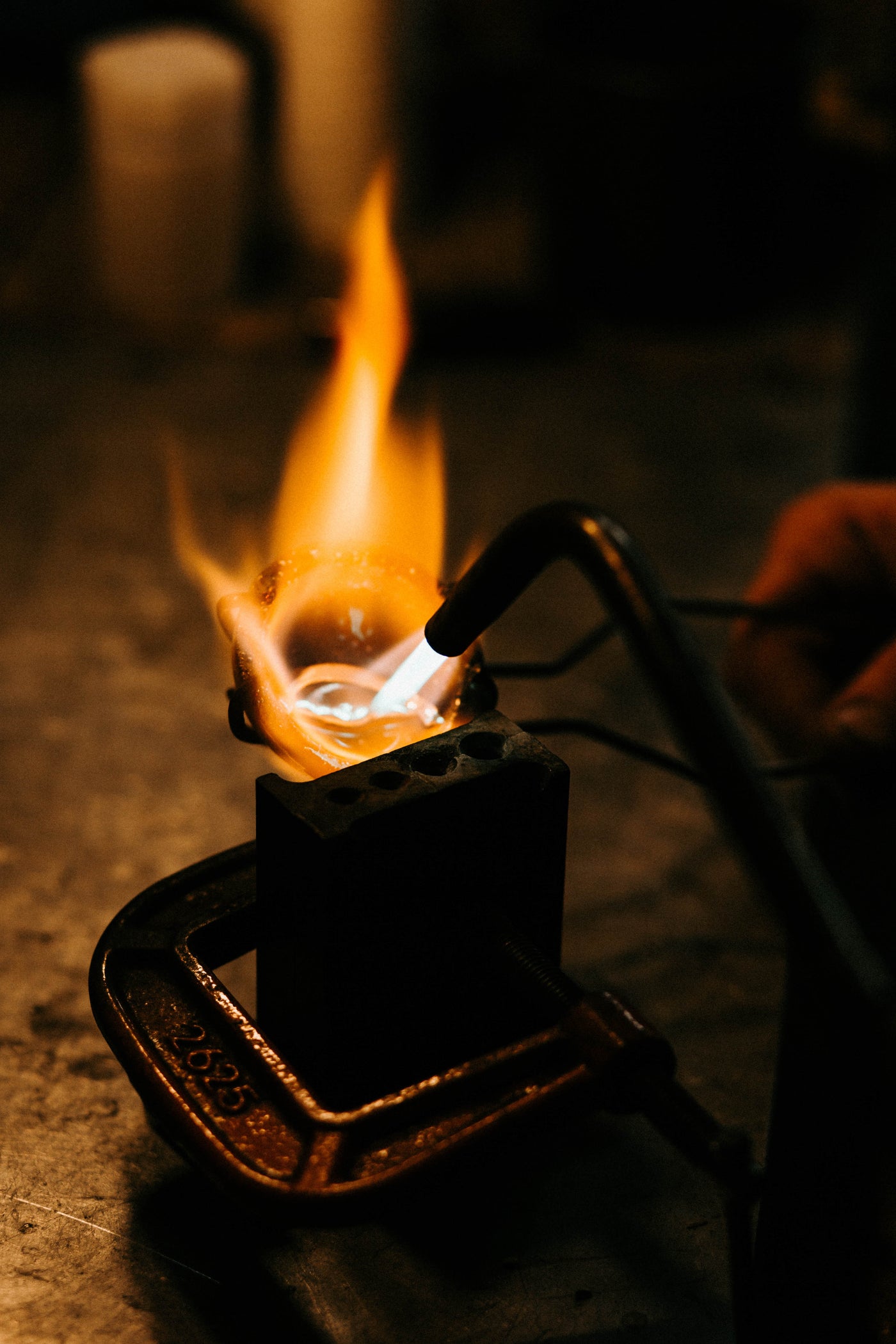 Torch melting metal for bolo tie 