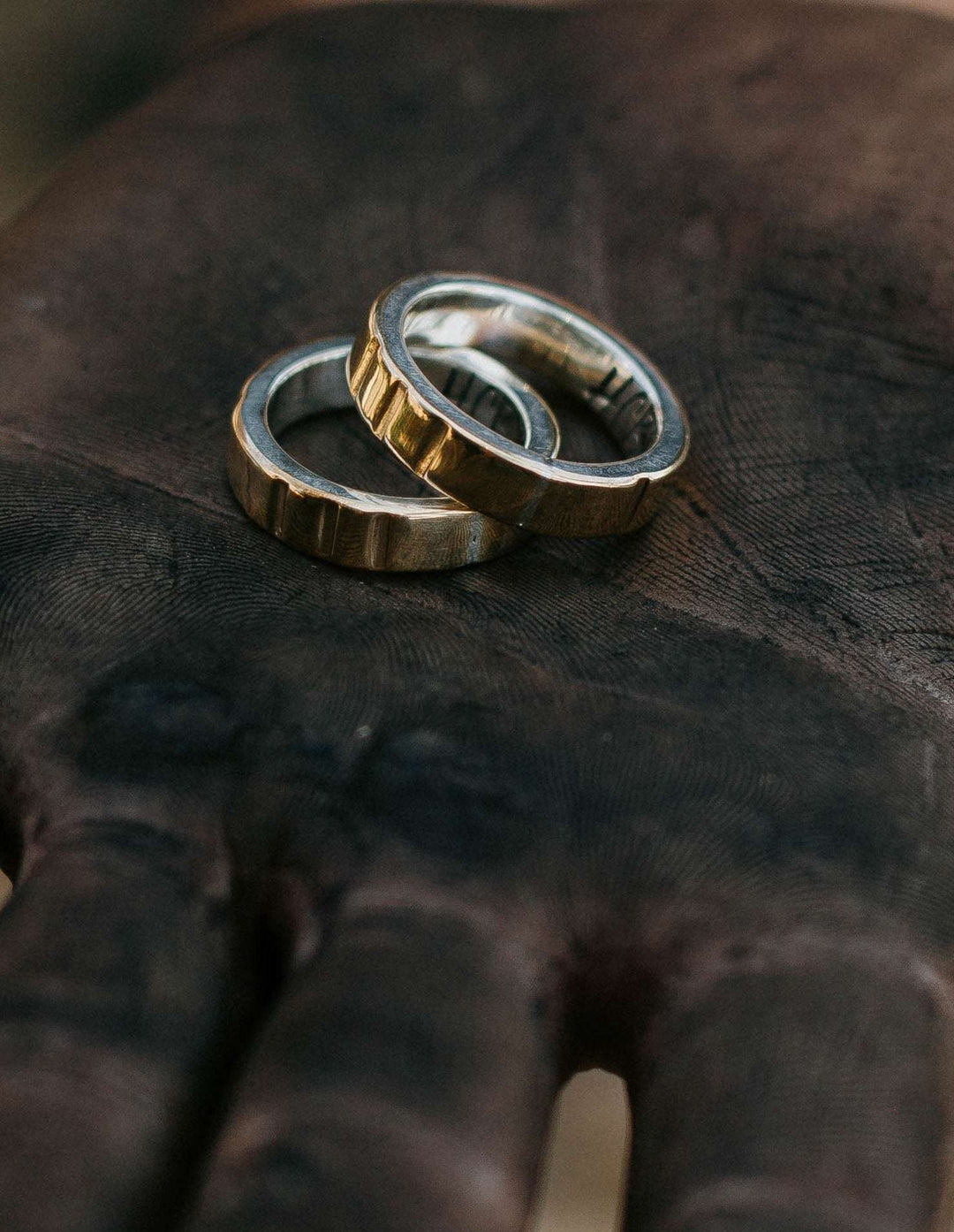 Hells Canyon Stamped Metal Wedding Bands in Hand