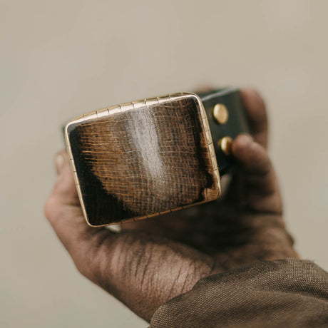 Our Western-inspired High Plains Driftwood Belt Buckle, meticulously handcrafted from stunning petrified wood, is a unique testament to nature's artistry. Each buckle showcases the rugged beauty of the high plains, elevating your Western look with its timeless charm and natural elegance.