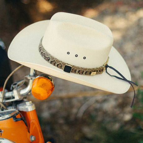 Elevate your hat game with our handcrafted rattlesnake leather hatband featuring a gem stud accent. Meticulously crafted to exude authentic Western spirit, this unique accessory adds rugged charm and timeless appeal to any cowboy hat. Stand out with style and sophistication inspired by the Wild West