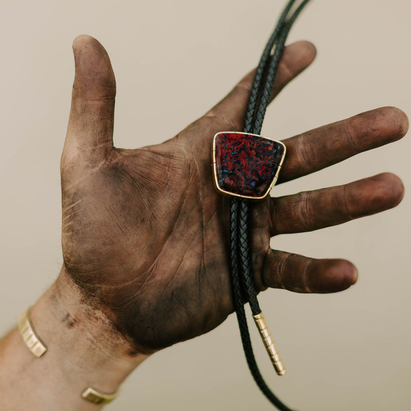 Carrey Moss Agate Bolo Tie With Black Cord In Hand